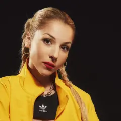 Viviana Casanova, con su edad, luce un look audaz con chaqueta amarilla, top deportivo Adidas y labios rojos.