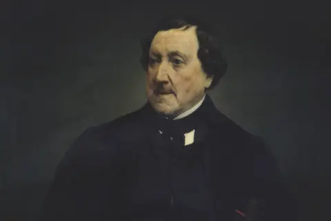 Retrato de un hombre con traje oscuro, quizás el compositor de las óperas de Rossini, con mirada pensativa.