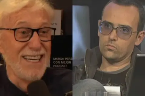 Dos hombres, uno sonriente con barba blanca y gafas, el otro con gafas de sol y expresión seria. Se busca productor musical para este proyecto.