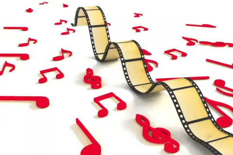 Una película se entrelaza con notas musicales rojas, ilustrando cómo es la música incidental, que acompaña y realza la narrativa visual.