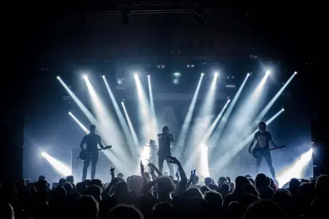 Banda de rock en vivo, luces brillantes y público eufórico. Una escena perfecta para inspirarte en cómo hacer un video musical épico.