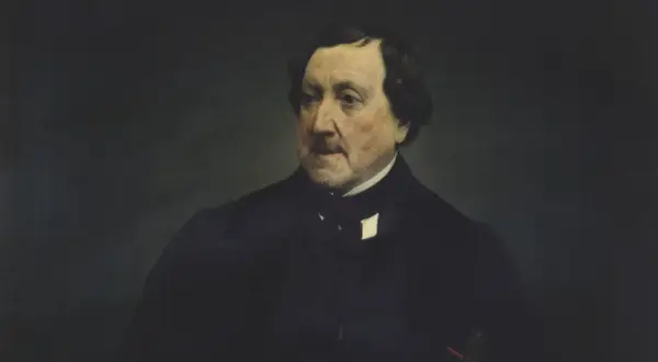 Retrato de un hombre con traje oscuro, quizás el compositor de las óperas de Rossini, con mirada pensativa.