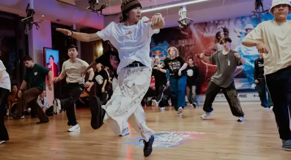 Jóvenes bailando breakdance en un estudio, capturando la energía de cuando se creó el hip hop.
