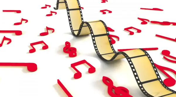 Una película se entrelaza con notas musicales rojas, ilustrando cómo es la música incidental, que acompaña y realza la narrativa visual.