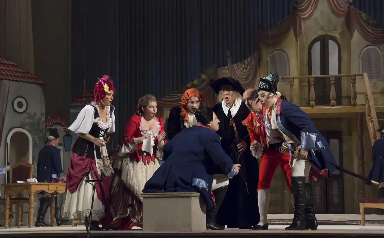 Actores en escena, con vestuarios de época, recrean una escena de las óperas de Rossini.