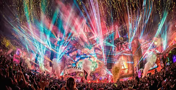 Multitud celebra en Tomorrowland, luces láser, confeti y fuegos artificiales crean un espectáculo mágico. ¡Así es como ir a Tomorrowland!